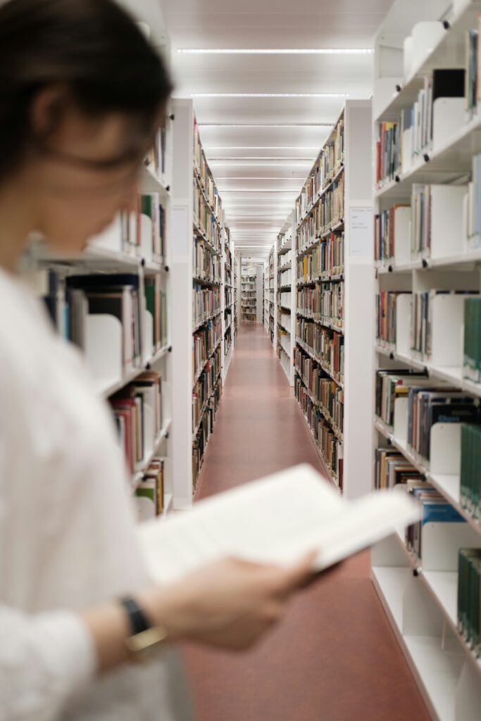 Research Person holding and reading a book in a library